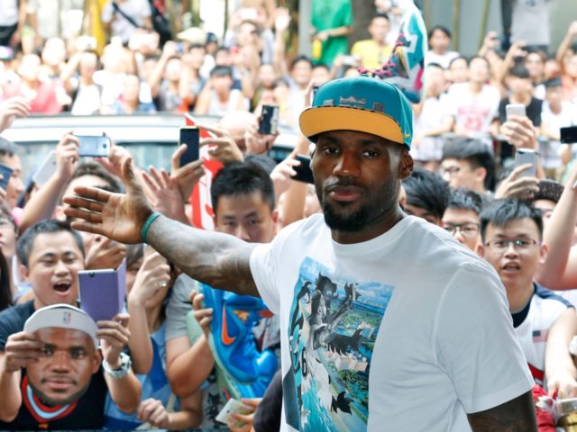 NBA star LeBron James poses with his fans during a promotional event at a shopping district in Hong Kong as part of his China tour Wednesday, July 23, 2014. Earlier this month, James left the Miami Heat after four seasons and four trips to the NBA Finals and re-signed with …