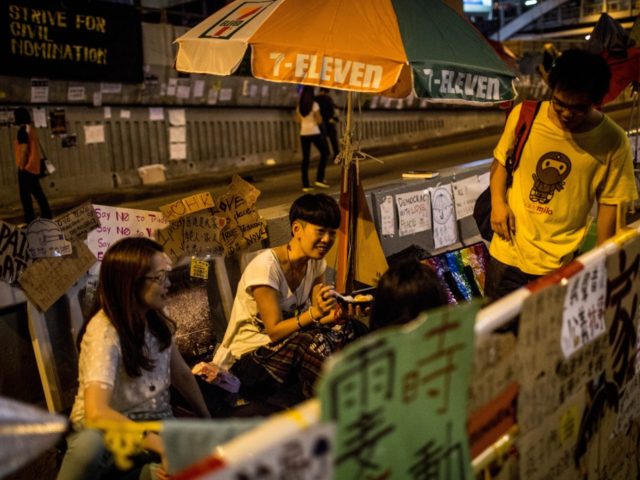 HONG KONG - OCTOBER 09: Pro-democracy activists eat dinner in the streets outside Hong Kon