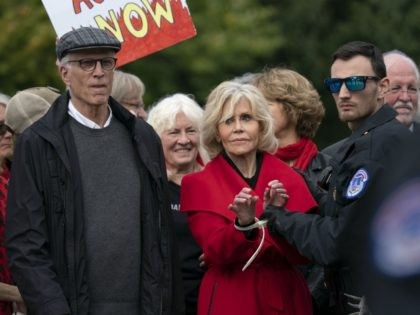 Actress and activist Jane Fonda, joined at left by actor Ted Danson, is arrested at the Ca