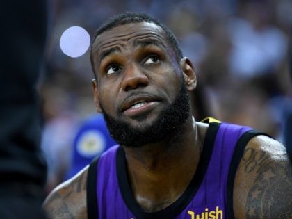 OAKLAND, CA - DECEMBER 25: LeBron James #23 of the Los Angeles Lakers looks on from the bench after he was hurt against the Golden State Warriors during the second half of their NBA Basketball game at ORACLE Arena on December 25, 2018 in Oakland, California. NOTE TO USER: User …