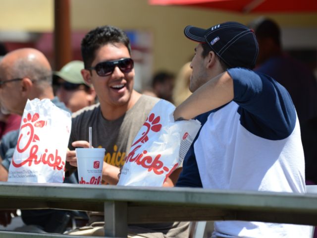 Two men prepare to have lunch on the patio of the Chick-fil-A in Hollywood, California, August 1, 2012. Thousands of Americans turned out Wednesday to feast on fried chicken in a politically-charged show of support for a family owned fast-food chain which opposes same-sex marriage. Long lines and traffic jams …