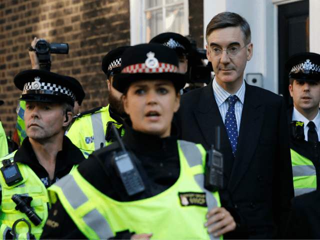 Police officers keep the pavement clear as Britain's Leader of …