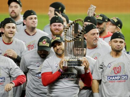 HOUSTON, TEXAS - OCTOBER 30: Manager Dave Martinez #4 of the Washington Nationals hoists the Commissioners Trophy after defeating the Houston Astros 6-2 in Game Seven to win the 2019 World Series in Game Seven of the 2019 World Series at Minute Maid Park on October 30, 2019 in Houston, …