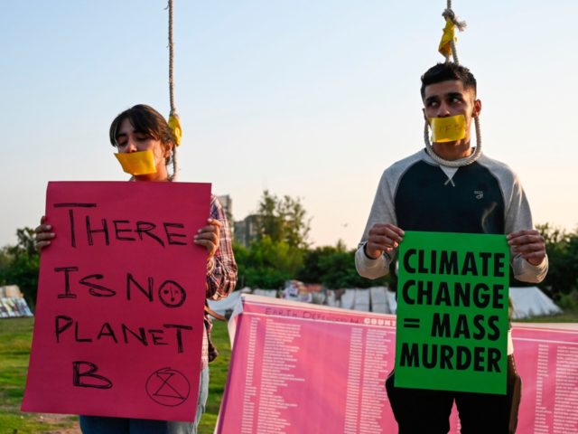 Climate activists having their lips taped hold placards as they take part in a 'Global Rebellion extinction protest' in Islamabad on October 9, 2019, as part of a planned series of protests around the world by the Extinction Rebellion movement. (Photo by Aamir QURESHI / AFP) (Photo by AAMIR QURESHI/AFP …