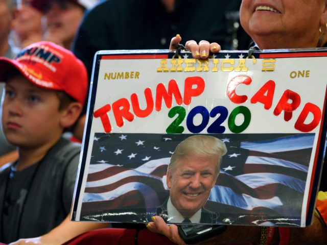 Supporters of US President Donald Trump listen as he speaks during a "Keep America Great"