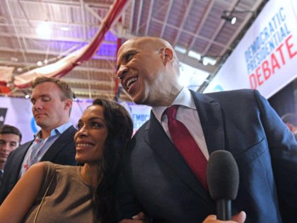 US actress Rosario Dawson (L) and boyfriend Democratic presidential hopeful New Jersey Senator Cory Booker pose for pictures in the spin room after the fourth Democratic primary debate of the 2020 presidential campaign season co-hosted by The New York Times and CNN at Otterbein University in Westerville, Ohio on October …