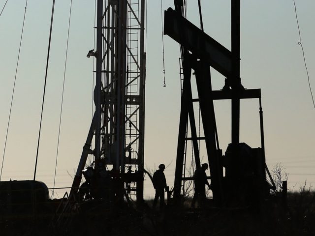 Workers for an oilfield service company work at a drilling site in the Permian Basin oil f