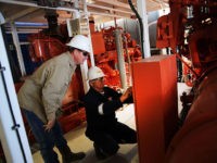 MENTONE, TX - FEBRUARY 05: Workers with Apache Corp. are viewed at the Patterson 298 natural gas fueled drilling rig on land in the Permian Basin on February 5, 2015 in Mentone, Texas. The rig, which is only 21 days old, is the first drilling rig in Texas that is …