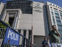 People walk by police barriers next to Istanbul's courthouse on September 18, 2019, during the trial of a US consulate staffer accused of spying and attempting to overthrow the government, in Istanbul. - A Turkish court ruled on September 18, 2019, that a US consular staffer would remain in jail …