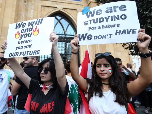 Lebanese demonstrators carry placards as they take part in a rally in the capital Beirut's