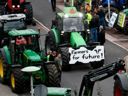 Farmers on tractors protest with a placard reading "Farmers for future" against the German