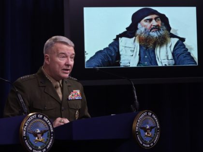 ARLINGTON, VIRGINIA - OCTOBER 30: U.S. Marine Corps Gen. Kenneth McKenzie, commander of U.S. Central Command, speaks as a picture of Abu Bakr al-Baghdadi is seen during a press briefing October 30, 2019 at the Pentagon in Arlington, Virginia. Gen. McKenzie and Hoffman spoke to the media to provide an …