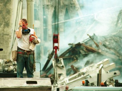 394375 05: A worker wipes his brow in the wreckage of the World Trade Center September 13, 2001 in New York City, two days after the twin towers were destroyed by two hijacked passenger jets. (Photo by Chris Hondros/Getty Images)