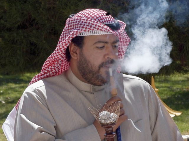ISFAHAN, IRAN - MARCH 15: OPEC President Sheikh Ahmad Fahd al-Sabah smokes a narguileh (sh