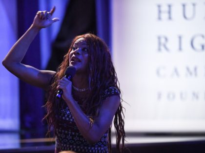 A transgendered woman audience member speaks during a town hall devoted to LGBTQ issues ho