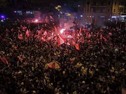 Lebanese protesters wave national flags as they take part in a rally in the northern city of Tripoli during the fourth day of demonstrations against tax increases and official corruption, on October 20, 2019. - Thousands continued to rally despite calls for calm from politicians and dozens of arrests. The …