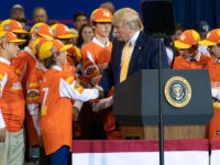 US President Donald Trump (C) shakes hands with a member of the Little League World Championship baseball team, the Eastbank All Stars of Louisiana, during a "Keep America Great" rally at Sudduth Coliseum at the Lake Charles Civic Center in Lake Charles, Louisiana, on October 11, 2019. (Photo by SAUL …