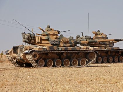 Turkish soldiers drive American-made M60 tanks in the town of Tukhar, north of Syria's nor