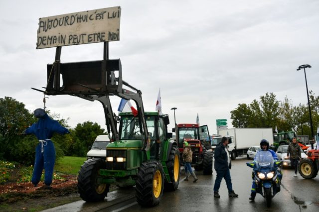 A tractor with a hanged effigy of a farmer under a sign saying "Today it's him, tomorrow it might be me," during a protest by farmers in Nimes, southern France, on Tuesday. French farmers stage protests as anger boils over