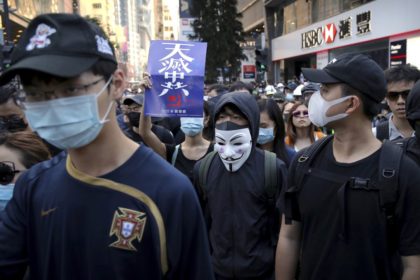 Demonstrators wearing masks gather during an anti-government protest in Hong Kong, Saturda