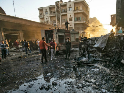 Security forces and civilians gather the site of bombings in the Syrian Kurdish-majority c