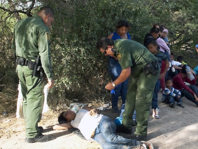 Border Patrol agents rescue a distressed migrant woman. (File Photo: U.S. Border Patrol/Barry Bahler)