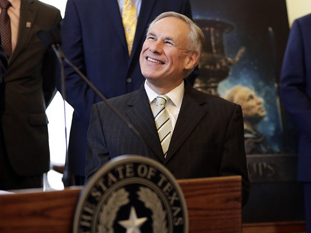 A poster with an image of Texas Gov. Greg Abbott is seen behind Abbott at a news conference where he was presented the Governor's Cup by Site Selection Magazine, Monday, March 4, 2019, in Austin, Texas. Texas won for having the most qualified projects of any state according to their …