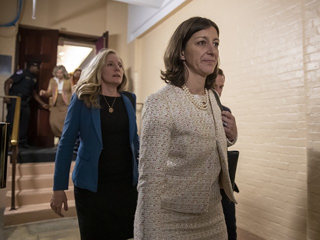 Rep. Elaine Luria, D-Va., right, followed by Rep. Abigail Spanberger, D-Va., left, leave a House Democratic Caucus meeting with Speaker of the House Nancy Pelosi, D-Calif., where she was persuaded to launch a formal impeachment inquiry against President Donald Trump, at the Capitol in Washington, Tuesday, Sept. 24, 2019. Rep. Luria and Rep. Spanberger are two of several freshmen Democrats with national security backgrounds who wrote an op-ed letter to the Washington Post calling for Trump's impeachment. (AP Photo/J. Scott Applewhite)