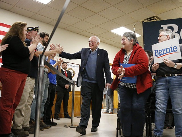 Democratic presidential candidate Sen. Bernie Sanders, I-Vt., high-fives supporters as he