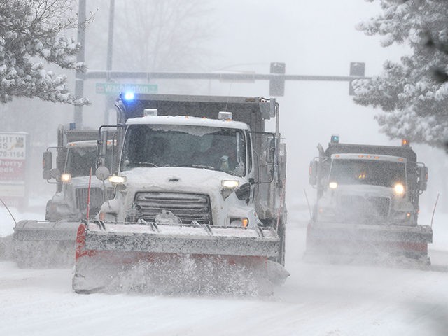 City of Denver snowplows clear the eastbound lanes of Speer Blvd. as a storm packing snow and high winds sweeps in over the region Tuesday, Nov. 26, 2019, in Denver. Stores, schools and government offices were closed or curtailed their hours while on another front, Thanksgiving Day travellers were forced …