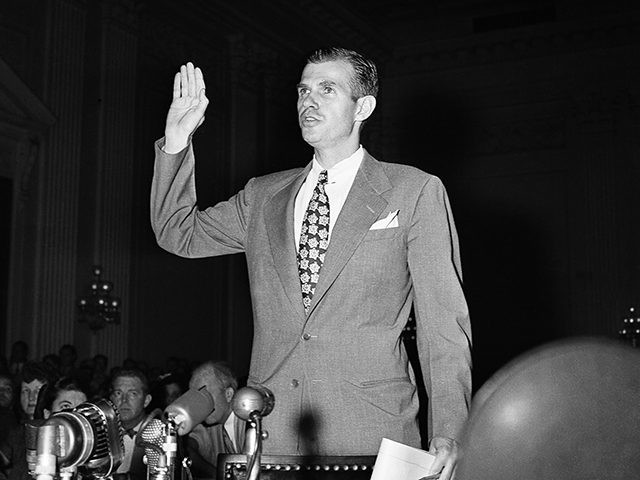 Alger Hiss, former State Department official, under accusation as aid to Communist wartime spy ring in Washington, August 25, 1948, examines record on the witness stand before the House Un-American Activities Committee; takes oath; arrives for hearing. (AP Photo)