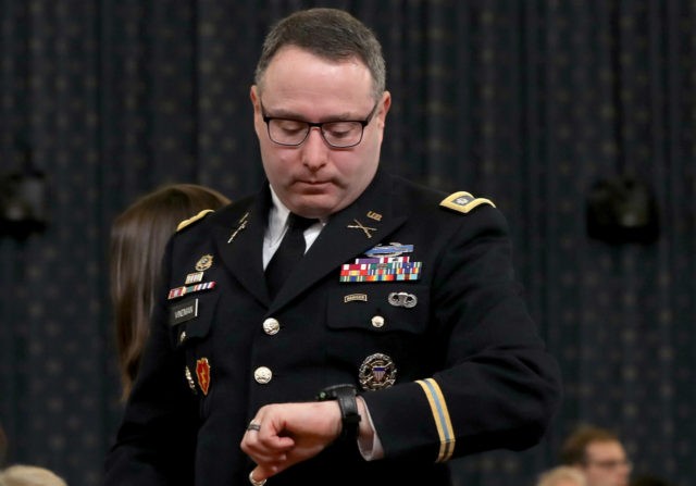 WASHINGTON, DC - NOVEMBER 19: Lt. Col. Alexander Vindman, National Security Council Director for European Affairs, checks his watch as he departs after testifying before the House Intelligence Committee in the Longworth House Office Building on Capitol Hill November 19, 2019 in Washington, DC. The committee heard testimony during the …
