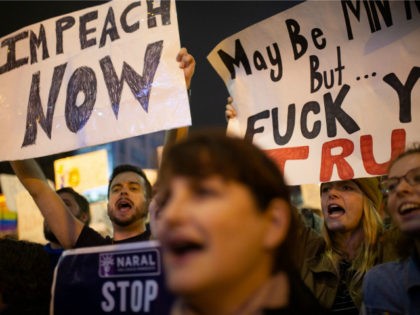 Anti-Trump protesters hold signs outside the Target Center in Minneapolis, Minnesota, ahea