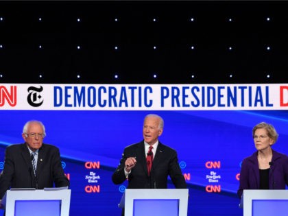 Democratic president hopefuls Vermont Senator Bernie Sanders (L) and Massachusetts Senator Elizabeth Warren (R) look on as former US Vice President Joe Biden speaks during the fourth Democratic primary debate of the 2020 presidential campaign season co-hosted by The New York Times and CNN at Otterbein University in Westerville, Ohio …