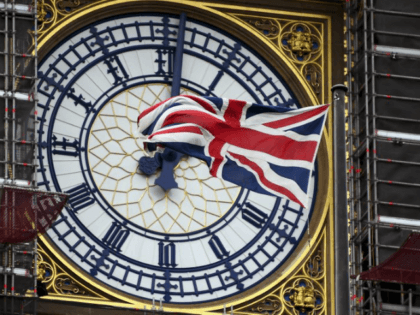A Union flag waves against the backdrop of the clock facade of the Elizabeth Tower, which