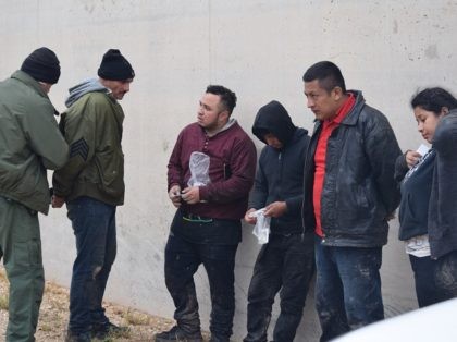 A McAllen Station Border Patrol agent apprehends five migrants from Mexico and Central Ame