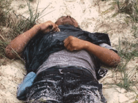 A Brooks County Sheriff's Office deputy recovers the body believed to be a Mexican migrant on a ranch 80 miles from the border. (Photo: Brooks County Sheriff's Office/Deputy J. Garcia)