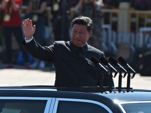 Chinese President Xi Jinping waves as he reviews troops from …