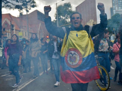 People demonstrate during a national strike in Bogota on November 25, 2019. - Colombia said Monday it is expelling 59 Venezuelans for taking part in street protests, as conservative President Ivan Duque gathered with business and labor leaders in a bid to quell violent anti-government protests. (Photo by RAUL ARBOLEDA …