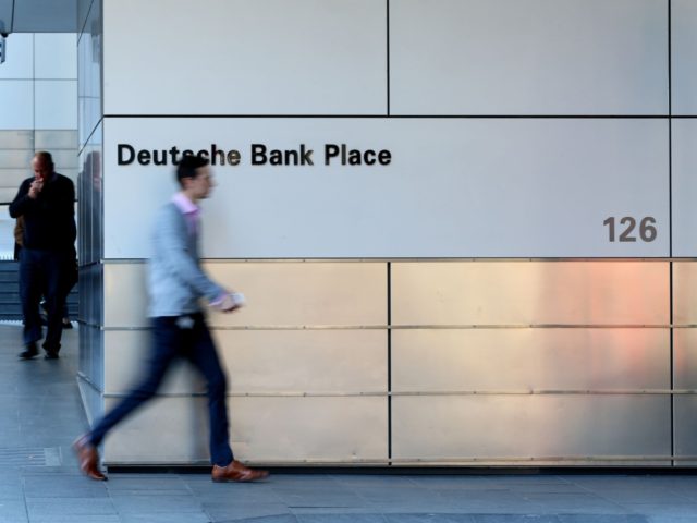 SYDNEY, AUSTRALIA - JULY 09: A man walks by Deutsche Bank signage on Phillip St on July 09