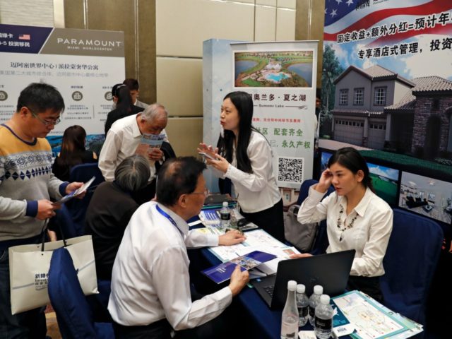 Chinese visitors seek information of the U.S. government's EB-5 visa program at the exhibitor booths in a Invest in America Summit, a day after an event promoting EB-5 investment in a Kushner Companies development held at a hotel in Beijing, Sunday, May 7, 2017. The sister of President Donald Trump's …