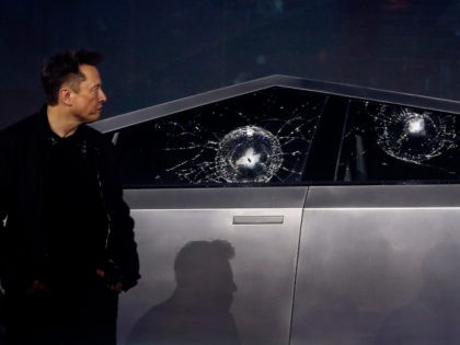 Elon Musk examines cracked Cybertruck windows