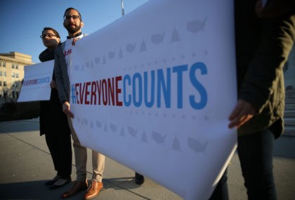 WASHINGTON, DC - DECEMBER 08: Activists hold signs during a news conference in front of the Supreme Court December 8, 2015 in Washington, DC. The Congressional Hispanic Caucus held the news conference on the day the Supreme Court hears oral arguments on Evenwel v. Abbott, "on whether voting districts should …