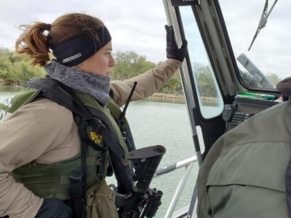 A female riverine Border Patrol agent stands watch during a shift on the Rio Grande. (Photo: Bob Price/Breitbart Texas)
