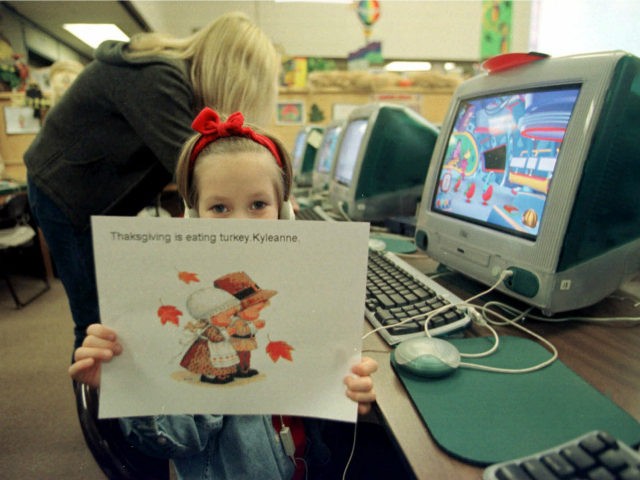 First-grader Kyleanne Kopping, 6, holds up a Thanksgiving picture she made on a computer at the April Lane Elementry School in Yuba City, Calif., Tuesday, Nov. 16, 1999. April Lane is starting an ambitious state program aimed at boosting student performance by the year 2002.(AP Photo/Rich Pedroncelli)