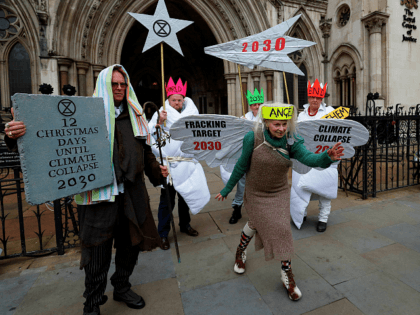 British fashion designer Vivienne Westwood, dressed as an angel, poses with other anti-fracking activists, dressed as Joseph, and the three wise men, as the demonstrate outside the Royal Courts of Justice, Britain's High Court, in central London on December 18, 2018. - Anti-fracking activists, including Talk Fracking, of which Westwood …