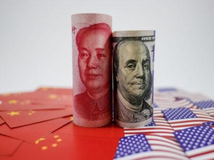 China yuan banknote on China flags and US dollar banknote on united states flags for trade war economy crisis concept.