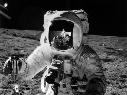 This 19 November 1969 file photo released by NASA shows one of the astronauts of the Apollo 12 space mission conducting experiment on the moon's surface with a camera. An other astronaut is reflected in his helmet. An Apollo / Saturn V space vehicle launched the Apollo 12 astronauts Charles …