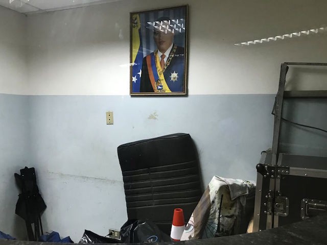 An image of the late Venezuela's president Hugo Chavez is pictured in a reception office -now used to place old stuff- at the Dr. Miguel Perez Carreno Hospital, in the west of Caracas, Venezuela on December 31, 2018. (Photo by YURI CORTEZ / AFP) (Photo credit should read YURI CORTEZ/AFP via Getty Images)