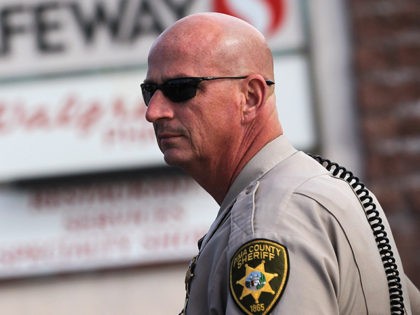 TUCSON, AZ - JANUARY 10: A sheriff's deputy stands guard near the crime scene of Friday's